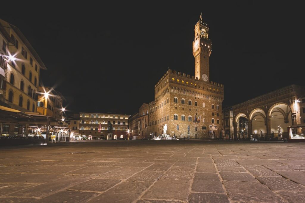Palazzo Vecchio piazza statues midday tourists