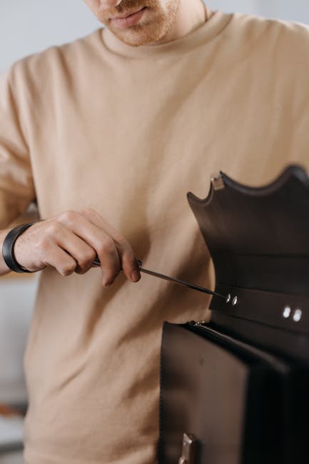 Leather workshop Florence artisan hands repairing bag