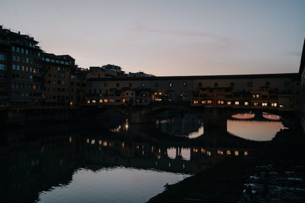 Ponte Vecchio silhouette over the Arno River at dusk in Florence.