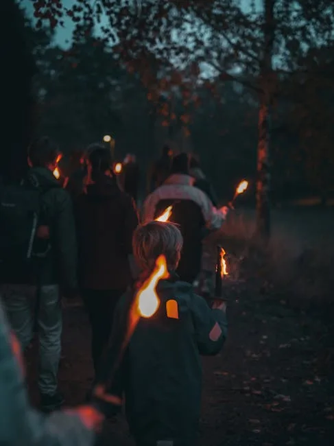 Fackelzug bei Dämmerung, Kind hält brennende Fackel auf dem Weg