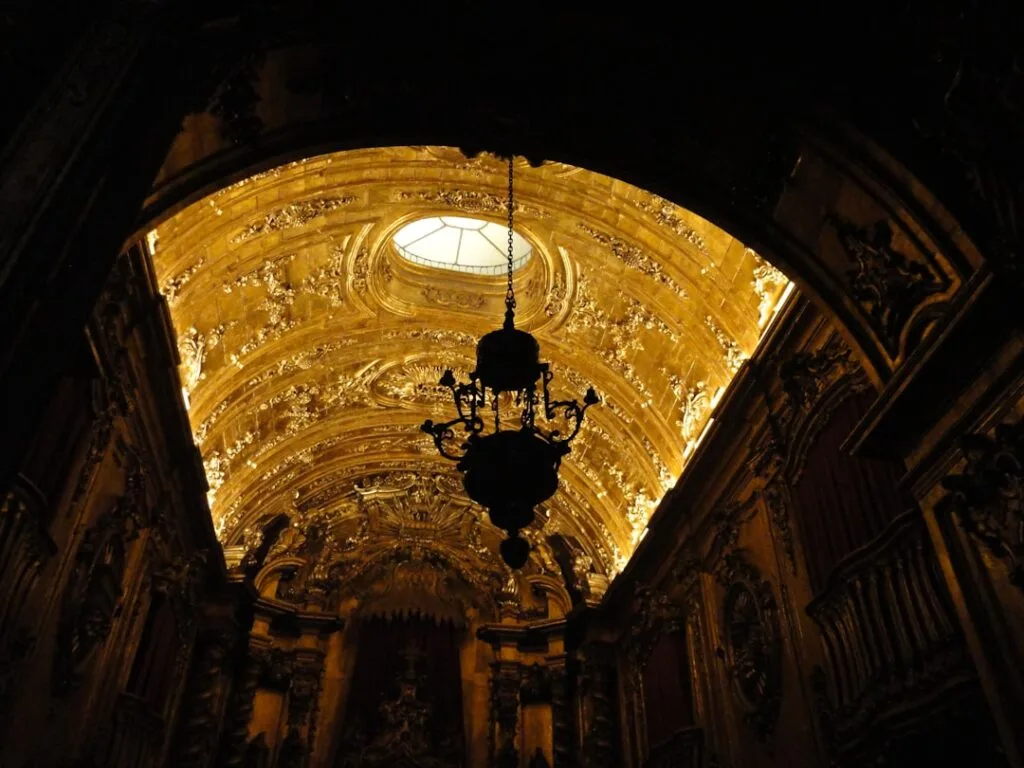 Opulent vergoldete Kassettendecke mit Kronleuchter in einer Kirche in Florenz