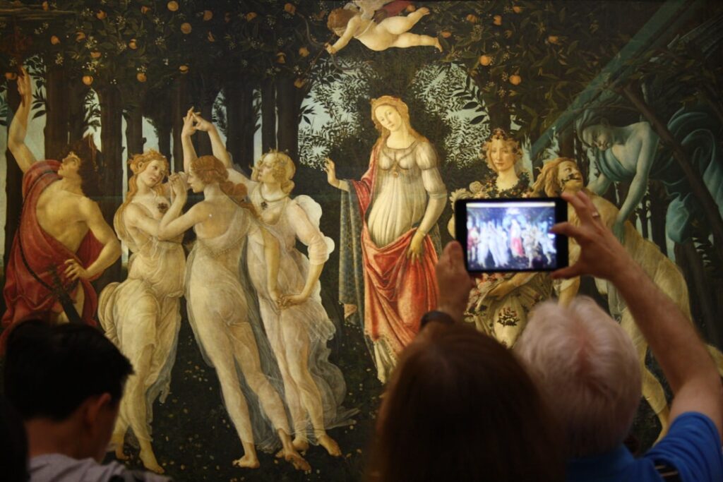 Visitors photographing Botticelli's Primavera at the Uffizi Gallery in Florence.