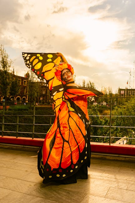 Performer in vivid monarch butterfly costume posing on a Florence terrace at sunset